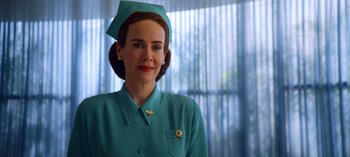 Movie still from “Ratched” (2020), created by Evan Romansky – A woman in a green dress and a blue hat; Close Up shot, Low angle