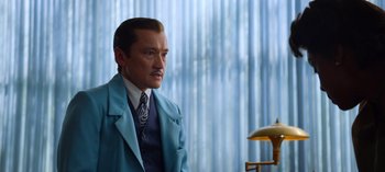 Movie still from “Ratched” (2020), created by Evan Romansky – A man in a blue suit and tie; Medium shot, Over the shoulder angle