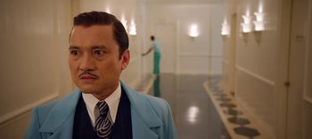 Movie still from “Ratched” (2020), created by Evan Romansky – A man in a suit and tie in a room; Close Up shot, Low angle