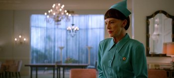 Movie still from “Ratched” (2020), created by Evan Romansky – An older woman in a green outfit looking to her left; Close Up shot, Low angle
