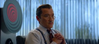 Movie still from “Ratched” (2020), created by Evan Romansky – An older man in a white shirt and red tie; Close Up shot, Over the shoulder angle