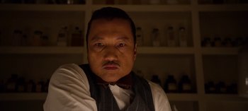 Movie still from “Ratched” (2020), created by Evan Romansky – A man with a bow tie is looking at the camera; Close Up shot, Low angle