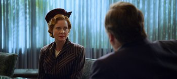 Movie still from “Ratched” (2020), created by Evan Romansky – An older woman wearing a hat talking to a younger man; Close Up shot, Over the shoulder angle