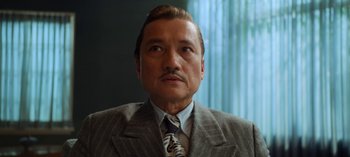 Movie still from “Ratched” (2020), created by Evan Romansky – A person wearing a suit and tie; Close Up shot, Low angle