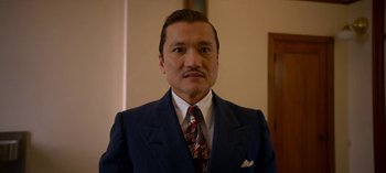 Movie still from “Ratched” (2020), created by Evan Romansky – A person wearing a suit and tie; Close Up shot, Low angle