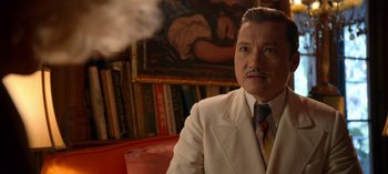Movie still from “Ratched” (2020), created by Evan Romansky – An older man in a white suit and tie; Close Up shot, Over the shoulder angle