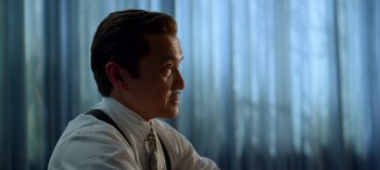 Movie still from “Ratched” (2020), created by Evan Romansky – A person wearing a suit and tie; Close Up shot, Over the shoulder angle