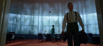 Movie still from “Ratched” (2020), created by Evan Romansky – A man and a woman standing in front of a large window; Medium shot, Low angle