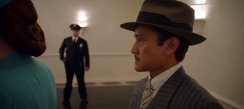 Movie still from “Ratched” (2020), created by Evan Romansky – A man in a suit and hat looking at a man in a suit and hat; Medium shot, Low angle