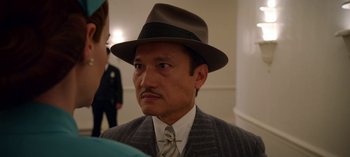 Movie still from “Ratched” (2020), created by Evan Romansky – A man wearing a suit and a hat; Close Up shot, Low angle