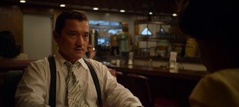 Movie still from “Ratched” (2020), created by Evan Romansky – A man sitting in front of a counter in a restaurant; Medium shot, Low angle