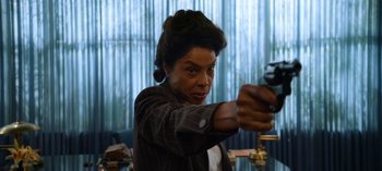 Movie still from “Ratched” (2020), created by Evan Romansky – A woman holding a gun in a room; Close Up shot, Low angle