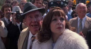 Movie still from “Rocky III” (1982), directed by Sylvester Stallone – An older man and a younger woman in a crowd of onlookers; Close Up shot, Over the shoulder angle