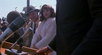 Movie still from “Rocky III” (1982), directed by Sylvester Stallone – A man and a woman are standing next to each other; Medium shot, Over the shoulder angle