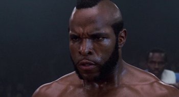 Movie still from “Rocky III” (1982), directed by Sylvester Stallone – A person with a bald head; Close Up shot, Low angle