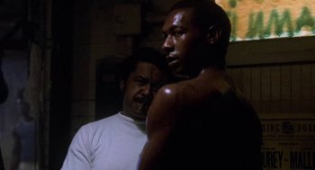 Movie still from “Rocky III” (1982), directed by Sylvester Stallone – Two men standing next to each other in the dark; Close Up shot, Low angle