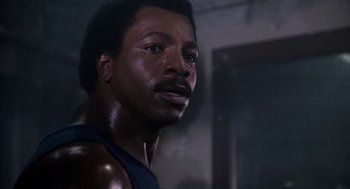 Movie still from “Rocky III” (1982), directed by Sylvester Stallone – A person wearing a tank top; Close Up shot, Low angle