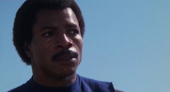 Movie still from “Rocky III” (1982), directed by Sylvester Stallone – A person with a beard and mustache; Close Up shot, Low angle