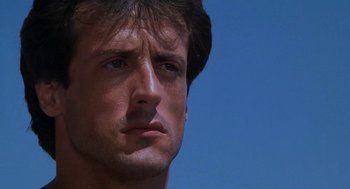Movie still from “Rocky III” (1982), directed by Sylvester Stallone – A man's face in the sunlight; Close Up shot, Low angle