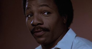 Movie still from “Rocky III” (1982), directed by Sylvester Stallone – A person with a beard and mustache; Close Up shot, Low angle