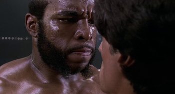 Movie still from “Rocky III” (1982), directed by Sylvester Stallone – A person with a beard; Close Up shot, Over the shoulder angle