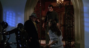 Movie still from “Rocky V” (1990), directed by John G. Avildsen – A group of people standing in front of a door; Wide shot, Low angle