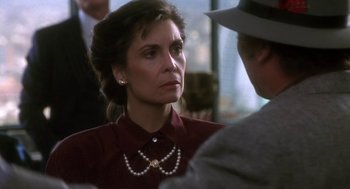 Movie still from “Rocky V” (1990), directed by John G. Avildsen – A person wearing a necklace; Close Up shot, Over the shoulder angle