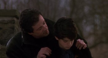 Movie still from “Rocky V” (1990), directed by John G. Avildsen – A man and a young boy hugging each other; Medium shot, Over the shoulder angle