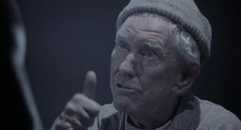 Movie still from “Rocky V” (1990), directed by John G. Avildsen – An old man giving a thumbs up in the dark; Close Up shot, Low angle