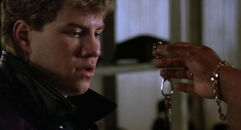 Movie still from “Rocky V” (1990), directed by John G. Avildsen – A young man holding a pair of keys in his hand; Close Up shot, Over the shoulder angle