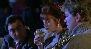 Movie still from “Rocky V” (1990), directed by John G. Avildsen – A woman holding a wine glass in her hand; Close Up shot, Over the shoulder angle