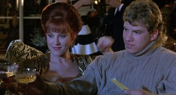 Movie still from “Rocky V” (1990), directed by John G. Avildsen – A woman and a man sitting next to each other; Close Up shot, Over the shoulder angle