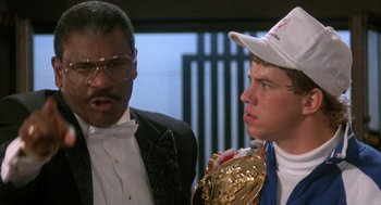 Movie still from “Rocky V” (1990), directed by John G. Avildsen – A man and a woman standing next to each other; Close Up shot, Over the shoulder angle