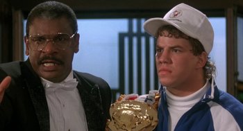 Movie still from “Rocky V” (1990), directed by John G. Avildsen – A man and a woman standing next to each other in a room; Close Up shot, Low angle
