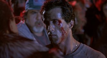 Movie still from “Rocky V” (1990), directed by John G. Avildsen – A person with blood on his face; Close Up shot, Over the shoulder angle