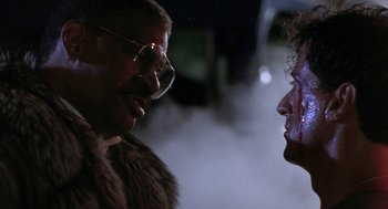 Movie still from “Rocky V” (1990), directed by John G. Avildsen – A man and a woman face to face in a foggy night; Close Up shot, Low angle