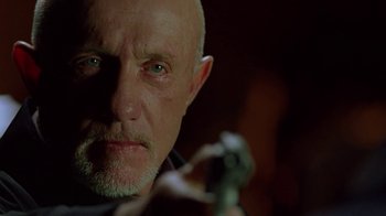 Movie still from “Breaking Bad” (2008), created by Vince Gilligan – A man with a beard is holding something in his hand; Close Up shot, Low angle