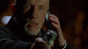 Movie still from “Breaking Bad” (2008), created by Vince Gilligan – An older man holding a cell phone to his ear; Close Up shot, Low angle