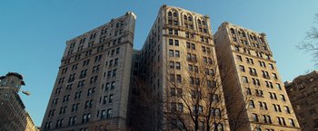 Movie still from “Salt” (2010), directed by Phillip Noyce – A tall building with a tree in front of it; Extreme Wide shot, Low angle