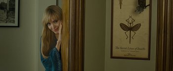 Movie still from “Salt” (2010), directed by Phillip Noyce – A woman leaning up against a wall in front of a mirror; Medium shot, Over the shoulder angle