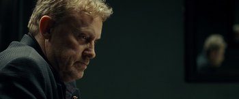 Movie still from “Salt” (2010), directed by Phillip Noyce – A person with white hair; Close Up shot, Over the shoulder angle
