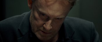Movie still from “Salt” (2010), directed by Phillip Noyce – A man's face as he stares into the distance; Close Up shot, Over the shoulder angle