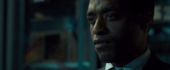 Movie still from “Salt” (2010), directed by Phillip Noyce – A person wearing a suit and tie; Close Up shot, Over the shoulder angle