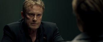 Movie still from “Salt” (2010), directed by Phillip Noyce – A person wearing a suit and tie; Close Up shot, Over the shoulder angle