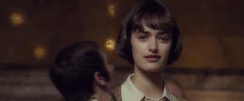 Movie still from “Salt” (2010), directed by Phillip Noyce – A young woman with short brown hair wearing a white shirt; Close Up shot, Over the shoulder angle