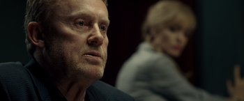 Movie still from “Salt” (2010), directed by Phillip Noyce – An older man looking into the distance while a woman looks on; Close Up shot, Over the shoulder angle