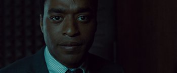Movie still from “Salt” (2010), directed by Phillip Noyce – A person wearing a suit and tie; Close Up shot, Over the shoulder angle