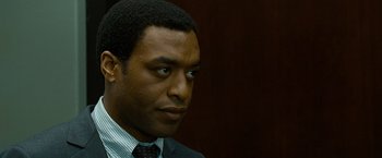 Movie still from “Salt” (2010), directed by Phillip Noyce – A person wearing a suit and tie; Close Up shot, Over the shoulder angle