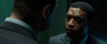 Movie still from “Salt” (2010), directed by Phillip Noyce – Two men in business suits talking to each other; Close Up shot, Over the shoulder angle