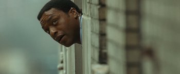 Movie still from “Salt” (2010), directed by Phillip Noyce – A person leaning against a brick wall; Close Up shot, Low angle